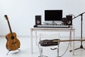 Microphone, computer and musical equipment guitars and piano background. Home recording studio concept.