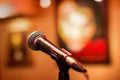 Microphone at a concert with a background in the form of pictures. Stage for performers with microphone stand for voice Royalty Free Stock Photo