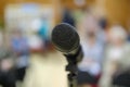 Microphone in concert hall or conference room with defocused bokeh lights in background. Extremely shallow dof Royalty Free Stock Photo