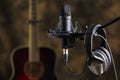 Microphone, earphones and acoustic guitar Royalty Free Stock Photo