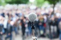 Microphone in focus against blurred crowd Royalty Free Stock Photo