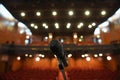 Microphone in front of an empty theatre hall