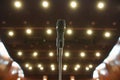 Microphone in front of an empty theatre hall