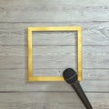 Microphone and gold frame on a gray wooden background. Text space. Top view. Minimal style. Podcast, voice, broadcast Royalty Free Stock Photo