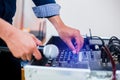 Microphone in hand and adjust an audio mixer controller in the control room, Sound mixer control for live music and studio Royalty Free Stock Photo