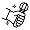 Microphone in hand icon, outline style Royalty Free Stock Photo