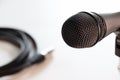 Microphone head closeup and balanced cable in background isolated on white Royalty Free Stock Photo