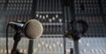 Microphone and Headphones on dirty sound mixer panel Royalty Free Stock Photo