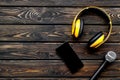 Microphone, headphones, mobile for blogger, journalist or musician work on wooden background top view mockup