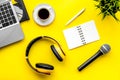 Microphone, headphones, notebook and laptop for blogger, journalist, musician work yellow background top view copyspace Royalty Free Stock Photo