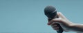 The microphone held firmly in a hand ready for performance..AI generated image Royalty Free Stock Photo