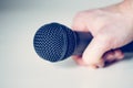 Microphone holding in hand with white background Royalty Free Stock Photo