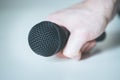 Microphone holding in hand with white background Royalty Free Stock Photo