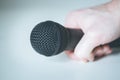 Microphone holding in hand with white background Royalty Free Stock Photo