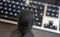 Microphone, mic condenser black metallic, blur keyboard background Royalty Free Stock Photo