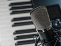 Microphone and midi keyboard, synthesizer. Close-up. Music, vocals, recording studio, concert, night club, music festival. There Royalty Free Stock Photo