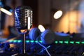 Microphone near professional mixing console and headphones in radio studio Royalty Free Stock Photo