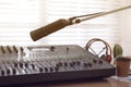 Microphone near professional mixing console in radio studio Royalty Free Stock Photo