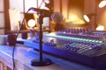 Microphone near professional mixing console on table in radio studio Royalty Free Stock Photo