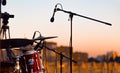 A microphone near a set of drums on the stage