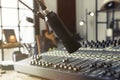 Microphone near table with professional mixing console in radio studio, closeup Royalty Free Stock Photo