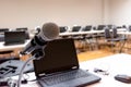 Microphone and Notebook on abstract blurred of speech in seminar room