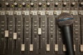 Microphone in old dirty sound mixer pult Royalty Free Stock Photo