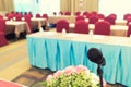 Microphone over the Abstract blurred photo of conference hall or seminar room with attendee background, Business meeting concept Royalty Free Stock Photo