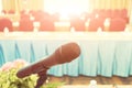 Microphone over the Abstract blurred photo of conference hall or seminar room with attendee background, Business meeting concept Royalty Free Stock Photo