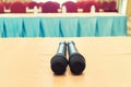 Microphone over the Abstract blurred photo of conference hall or seminar room with attendee background, Business meeting concept Royalty Free Stock Photo