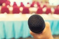 Microphone over the Abstract blurred photo of conference hall or seminar room with attendee background, Business meeting concept Royalty Free Stock Photo