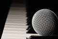 Microphone on a piano keyboard. Royalty Free Stock Photo