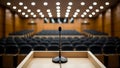 Microphone on a podium in an empty conference hall ready for a presentation, public speech, lecture, or event Royalty Free Stock Photo