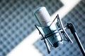 Microphone in a professional recording or radio studio, sound insulation in the blurry background Royalty Free Stock Photo