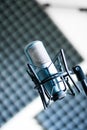 Microphone in a professional recording or radio studio, sound insulation in the blurry background Royalty Free Stock Photo