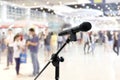Microphone public relations on Blurred many People within Department store Shopping Mall Event hall inside background