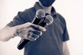 Close up hand holding microphone for speaker speech presentation stage performance and Royalty Free Stock Photo
