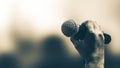 Microphone Public speaking background, Close-up hand holding microphone on stand for speaker speech presentation stage performance