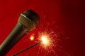 Microphone on red background and sparkler Royalty Free Stock Photo