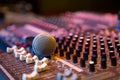 Microphone resting on a sound console