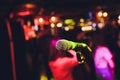 Microphone on stage against a background of auditorium. Royalty Free Stock Photo