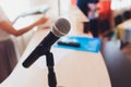 Microphone on stage against a background of auditorium. Royalty Free Stock Photo