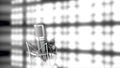 Microphone on stage with bright, blurred spotlights on background, monochrome. Abstract silver mic standing in front of Royalty Free Stock Photo