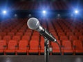 Microphone on the stage of concert hall or theater with red seat Royalty Free Stock Photo