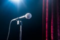 Microphone on a stand up comedy stage with reflectors ray, high contrast image