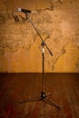 Microphone on stand against brick wall on wooden floor Royalty Free Stock Photo