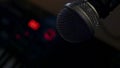 Microphone on a stand located in a music studio recording booth under low key light Royalty Free Stock Photo