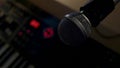 Microphone on a stand located in a music studio recording booth under low key light Royalty Free Stock Photo