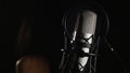 Microphone on a stand located in a music studio recording booth under low key light Royalty Free Stock Photo