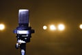 a microphone on a stand in a stage with spotlights in the background Royalty Free Stock Photo